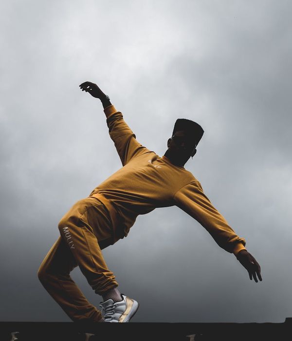 Silhouette of a person in a yoga pose with vibrant energy lines.